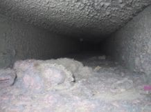 An air duct filled with dust and debris